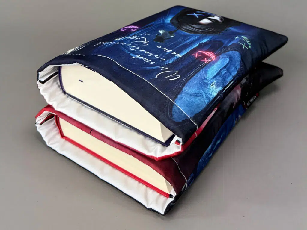 Zwei fertige Buchhuellen mit eingelegten Hardcover-Buechern